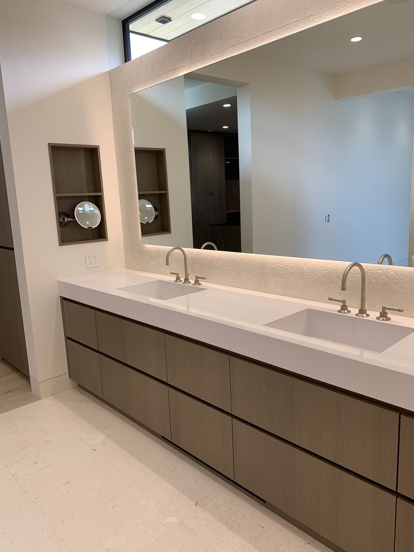 Custom double bathroom vanity in wood with a marble countertop and backlit niches, San Diego