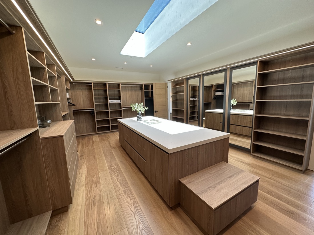 Custom walk-in closet with wood shelving and a center island, San Diego